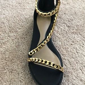Black asymmetrical gold chain sandals